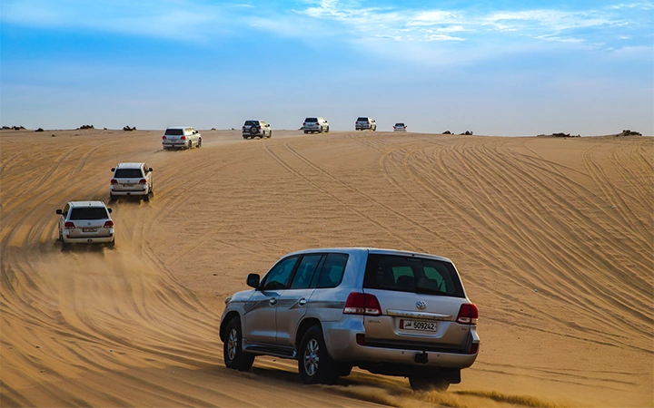 SUV convoy on desert dunes in Doha Qatar safari