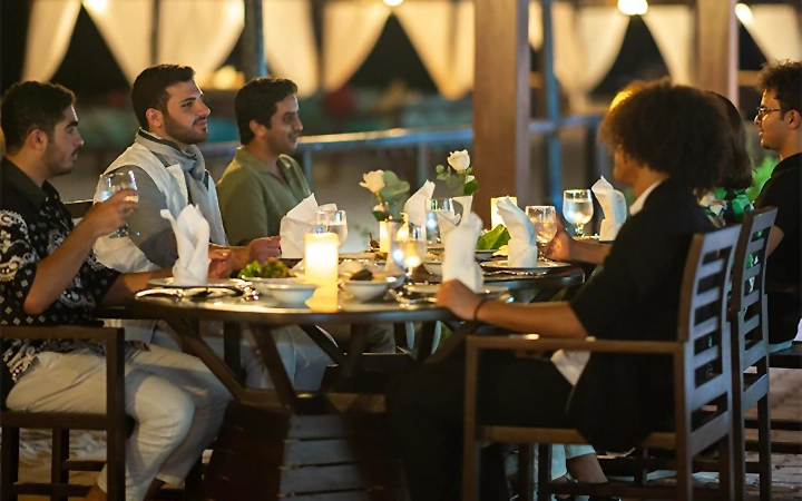 Tourists enjoying dinner at desert safari Qatar