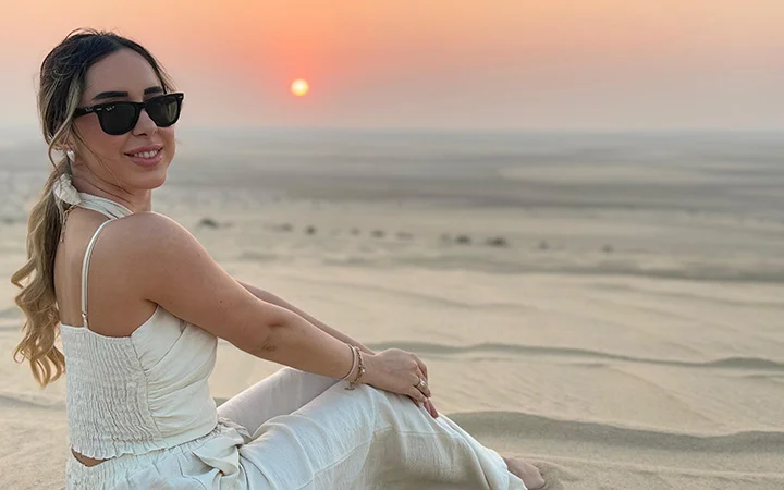 Woman enjoying desert sunset during Wild Dunes Desert Safari Qatar