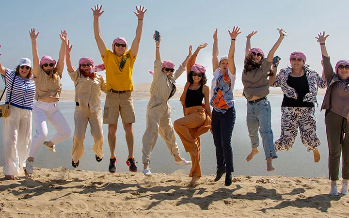 Tourists jumping with joy on desert safari Qatar